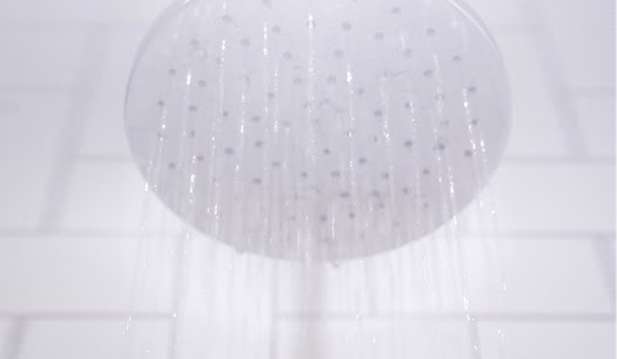 white rain shower head with white bathroom tile